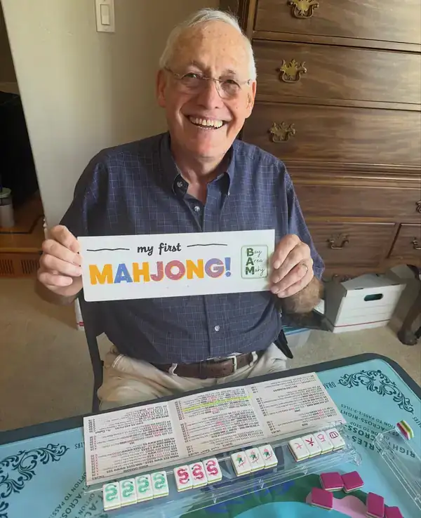 Dave proudly showing off his first mahjong certificate at a Bay Area Mahj class